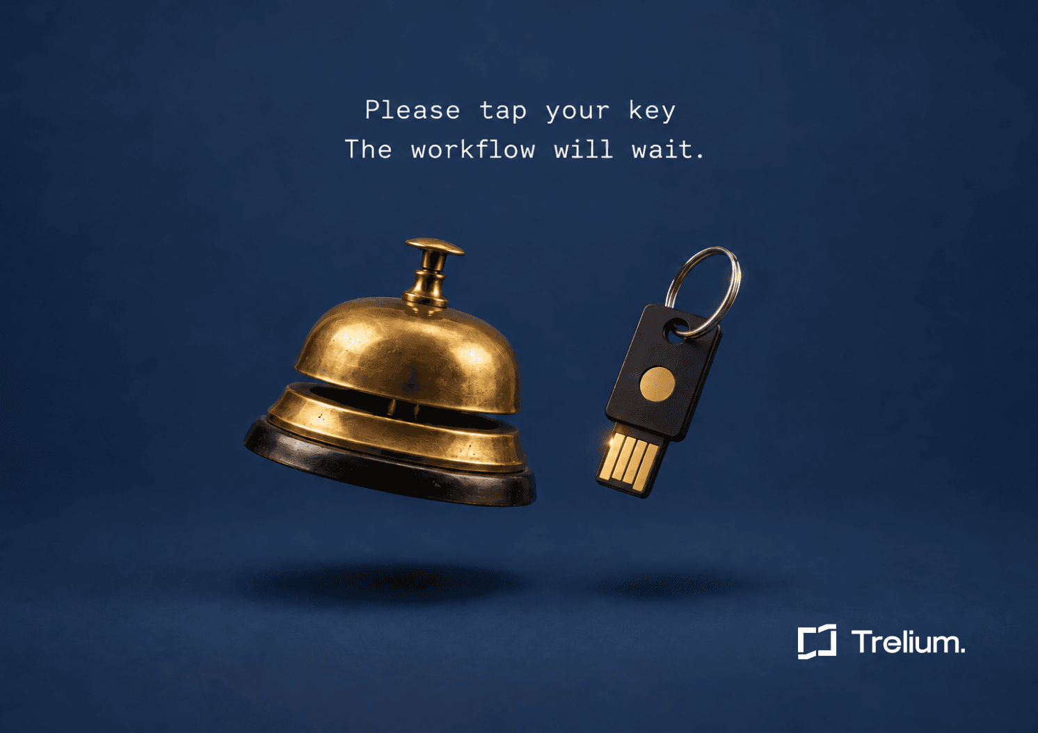 A brass hotel service bell floats beside a black USB security key on a keyring against a navy background.
