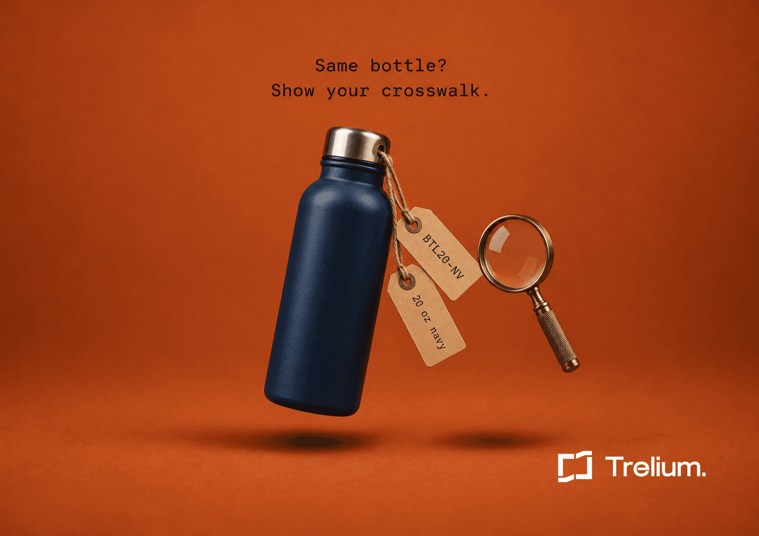 A navy water bottle floats against an orange background, two kraft tags reading BTL20-NV and 20 oz navy hanging from its cap beside a brass magnifying glass.